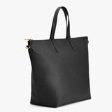 Tote bag with two handles and gold-tone hardware on a plain background.