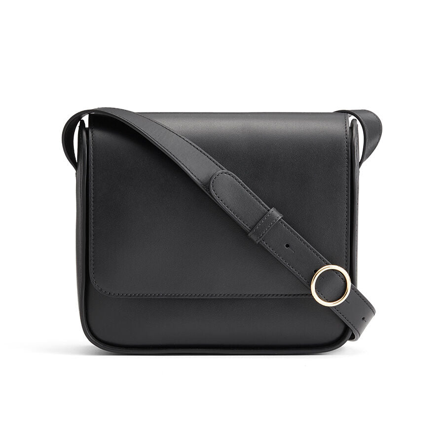 Black shoulder bag with a circular handle on the strap.