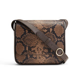 Patterned shoulder bag with an adjustable strap and metal ring detail.