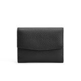 Small wallet with textured surface on a plain background.