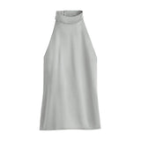 Sleeveless high-neck top on a plain background.