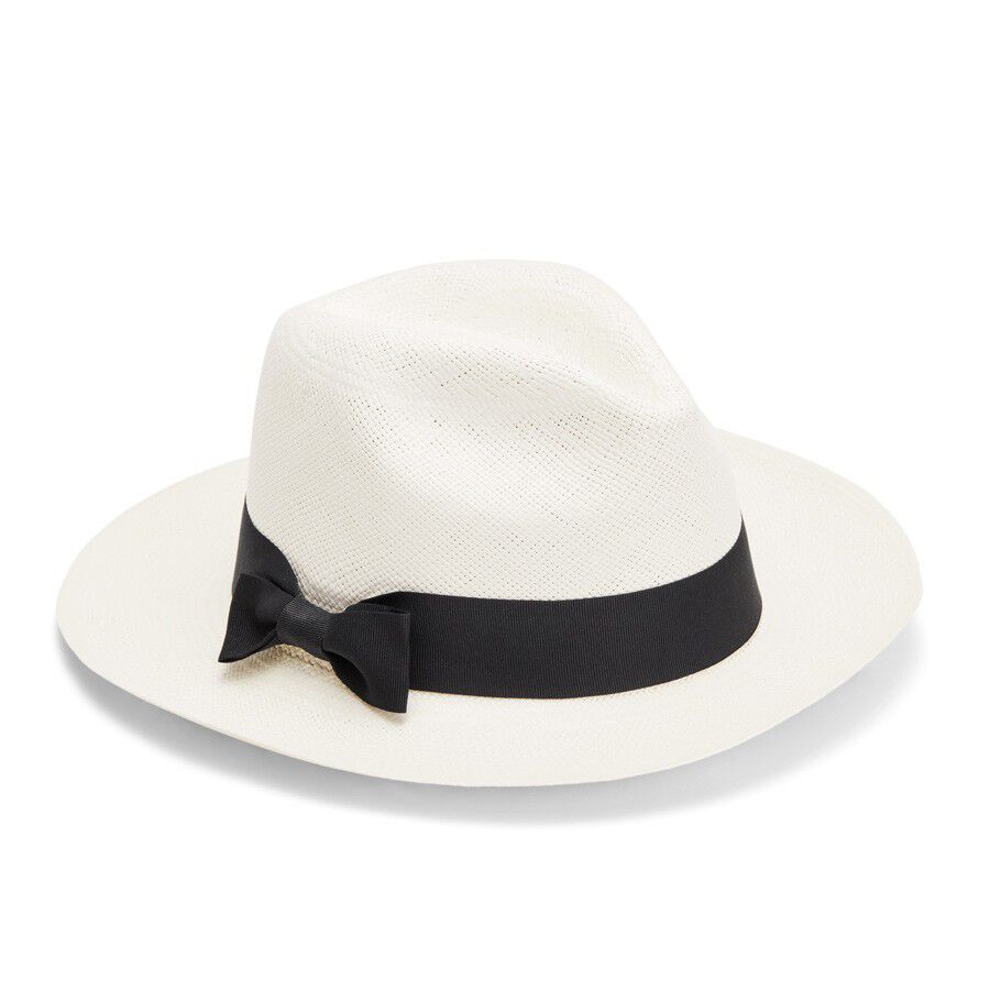 Straw hat with a ribbon bow on a plain background.