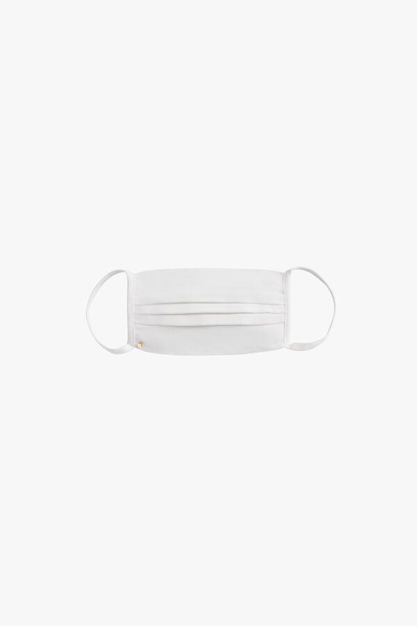 Surgical mask with elastic bands floating against a white background.