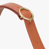 Belt with circular metal buckle and punch holes.
