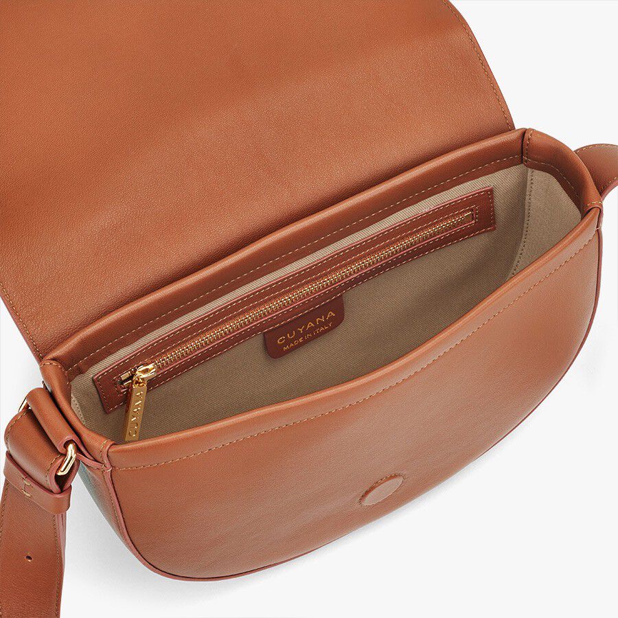 Open handbag showing interior and zipper pocket.