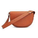 Saddle-shaped shoulder bag with adjustable strap and circular clasp