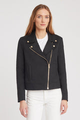 Woman wearing a jacket with asymmetrical zipper and white top