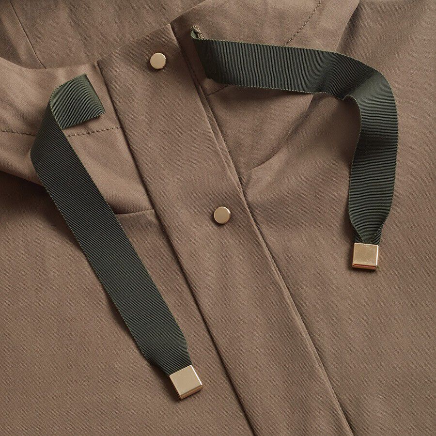 Close-up of a shirt with suspenders featuring metal clips.