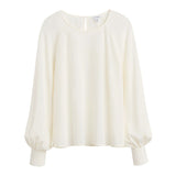 Long-sleeved blouse with round neckline and elastic cuffs.